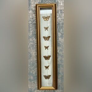 Custom brass butterflies artwork. Fabric looks like light blue moire.